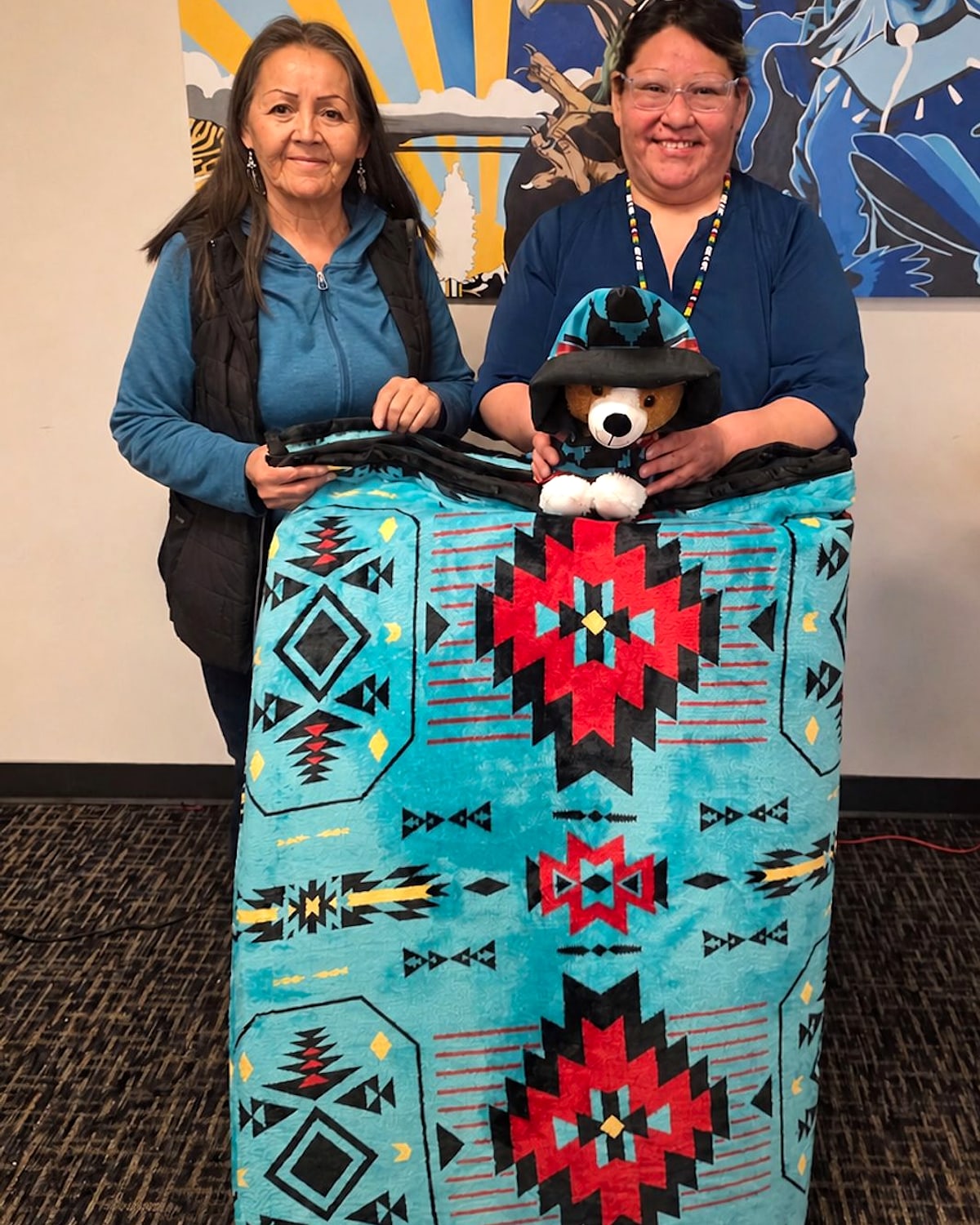 Bonita and Hayley holding a handcrafted Imitah pet bed in Calgary